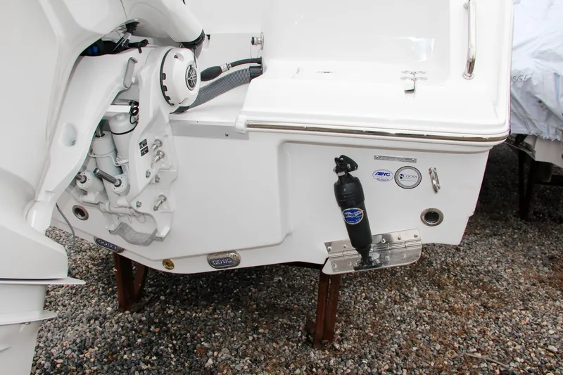 Slide: The Image of 2024 Sea Hunt Ultra 234 boat stern with motor and trim tabs. - 7