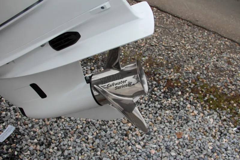 Slide: The Image of 2024 Sea Hunt Ultra 234 boat propeller on gravel surface. - 8