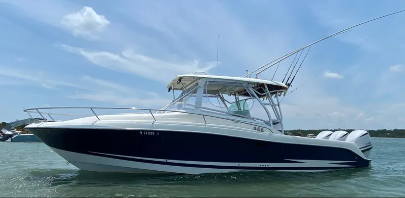 Slide: The Image of 2005 Hydra-Sports Vector 3300 VX boat on water under clear sky. - 2