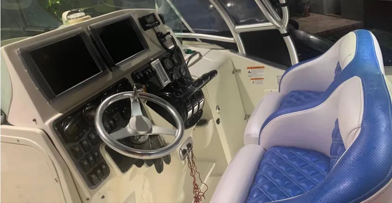 Slide: The Image of 2005 Hydra-Sports Vector 3300 VX boat cockpit with dual screens and blue seating. - 8