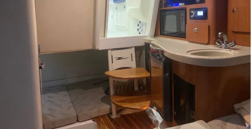 Slide: The Image of 2005 Hydra-Sports Vector 3300 VX cabin interior with kitchenette and seating area. - 9