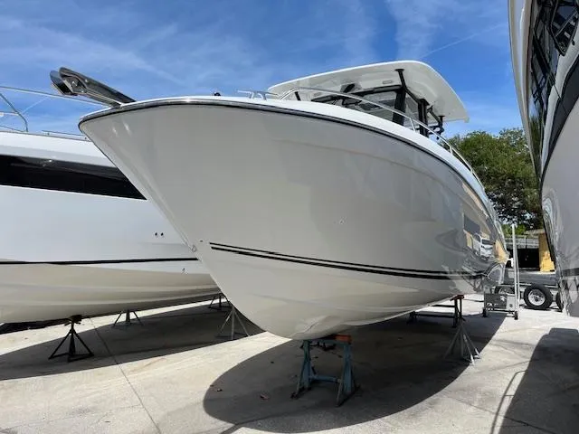 Slide: The Image of 2024 Jeanneau Leader 12.5 WA boat on stands, side view. - 1