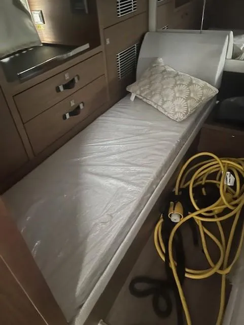 Slide: The Image of 2024 Jeanneau Leader 12.5 WA cabin interior with bed and storage. - 10