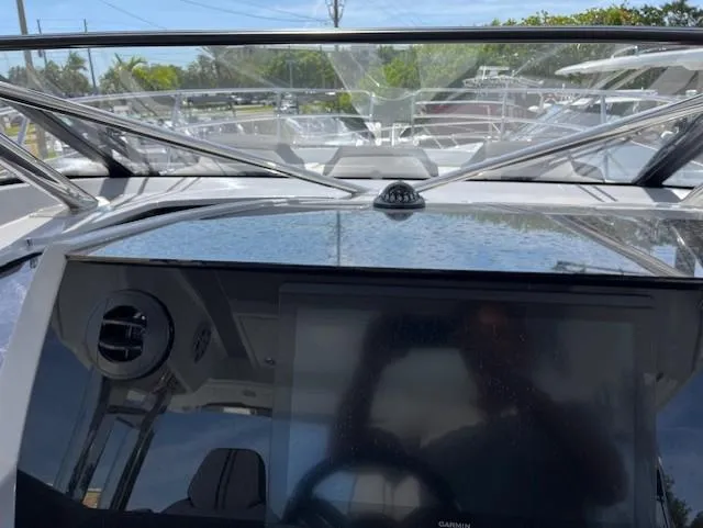 Slide: The Image of 2024 Jeanneau Leader 12.5 WA helm station with windshield and navigation display. - 17