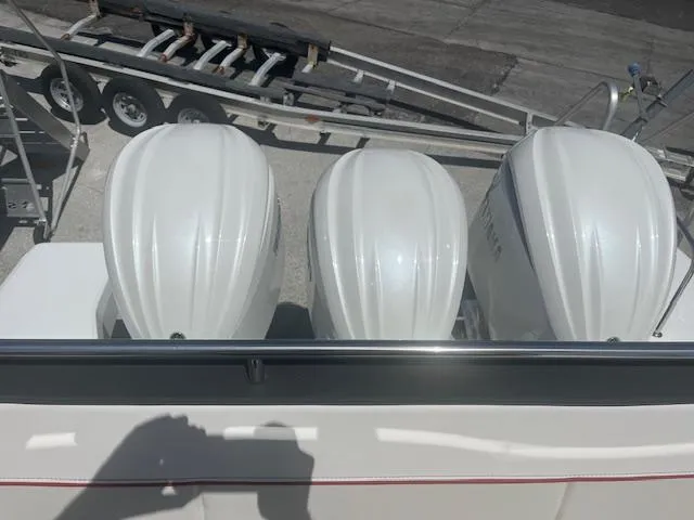 Slide: The Image of Triple outboard engines on a 2024 Jeanneau Leader 12.5 WA boat. - 20