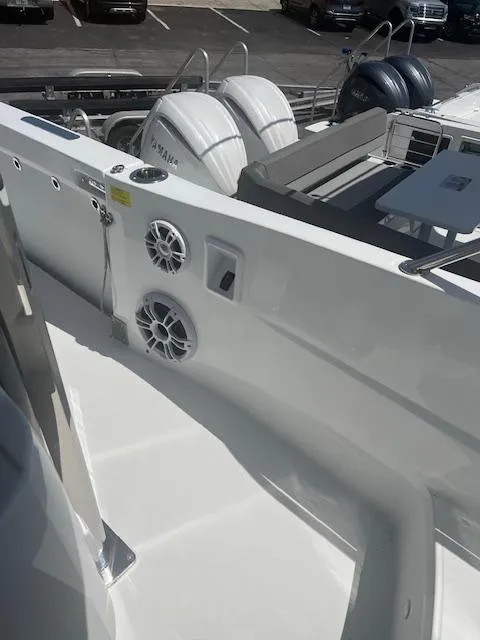 Slide: The Image of 2024 Jeanneau Leader 12.5 WA boat deck with speakers and Yamaha engines. - 21