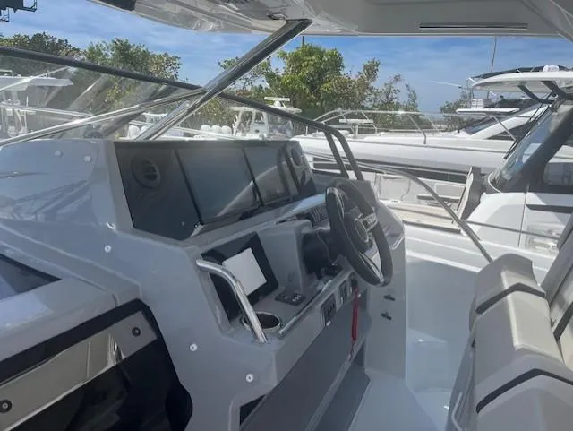 Slide: The Image of 2024 Jeanneau Leader 12.5 WA boat cockpit with modern navigation equipment. - 22