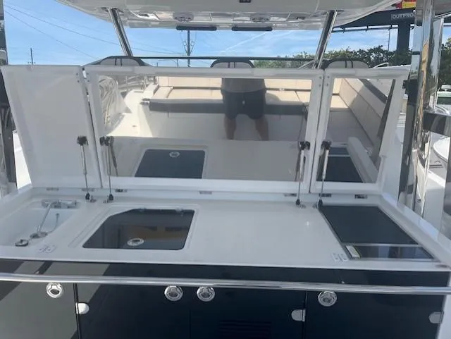 Slide: The Image of 2024 Jeanneau Leader 12.5 WA boat with open deck and kitchen area. - 26