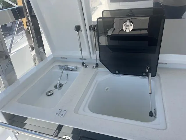 Slide: The Image of 2024 Jeanneau Leader 12.5 WA boat sink and storage compartments. - 27