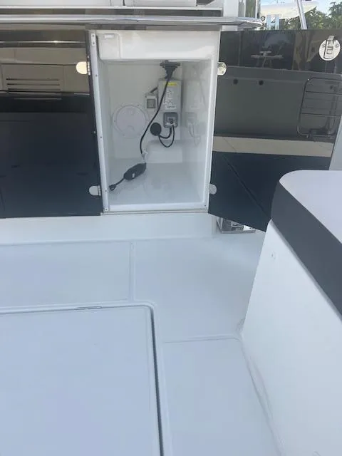 Slide: The Image of 2024 Jeanneau Leader 12.5 WA boat interior with open storage compartment. - 29