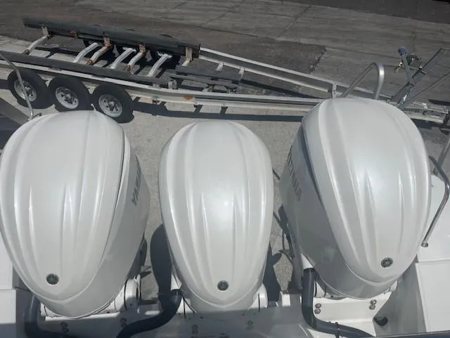 Slide: The Image of Triple outboard engines on a 2024 Jeanneau Leader 12.5 WA boat. - 3