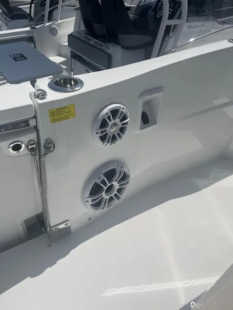 Slide: The Image of 2024 Jeanneau Leader 12.5 WA boat interior with speakers and seating area. - 31