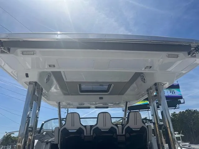 Slide: The Image of 2024 Jeanneau Leader 12.5 WA boat interior with seating and overhead view. - 4