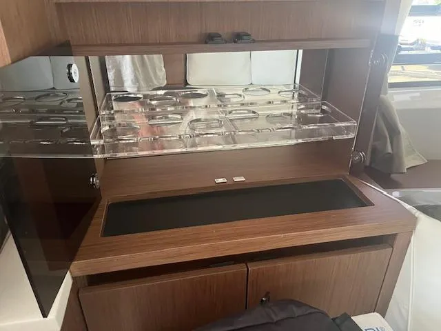 Slide: The Image of 2024 Jeanneau Leader 12.5 WA interior cabin with wooden cabinetry and storage. - 9