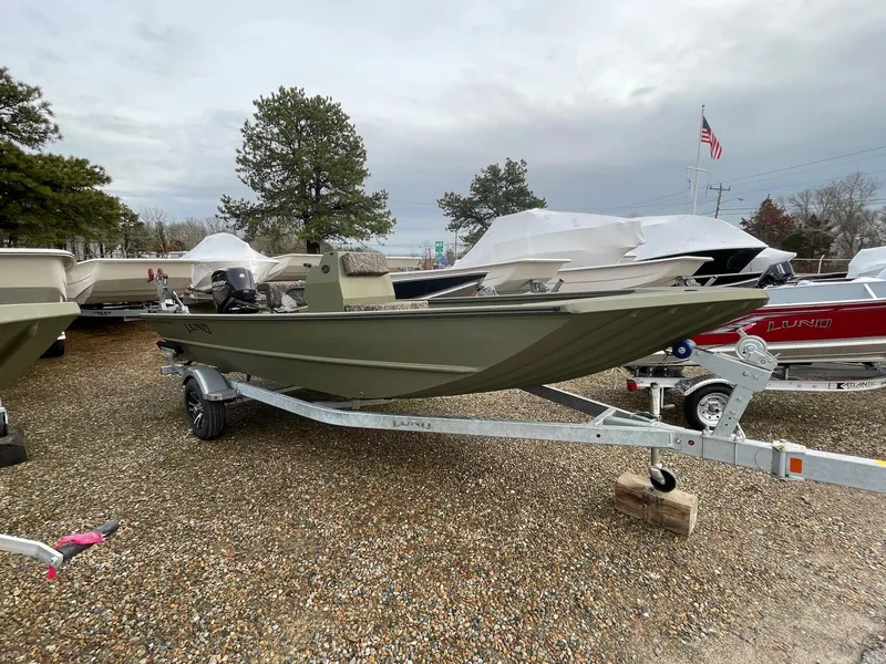 The Image of 2024 Lund 1870 Predator boat on a trailer in a boatyard. - 0