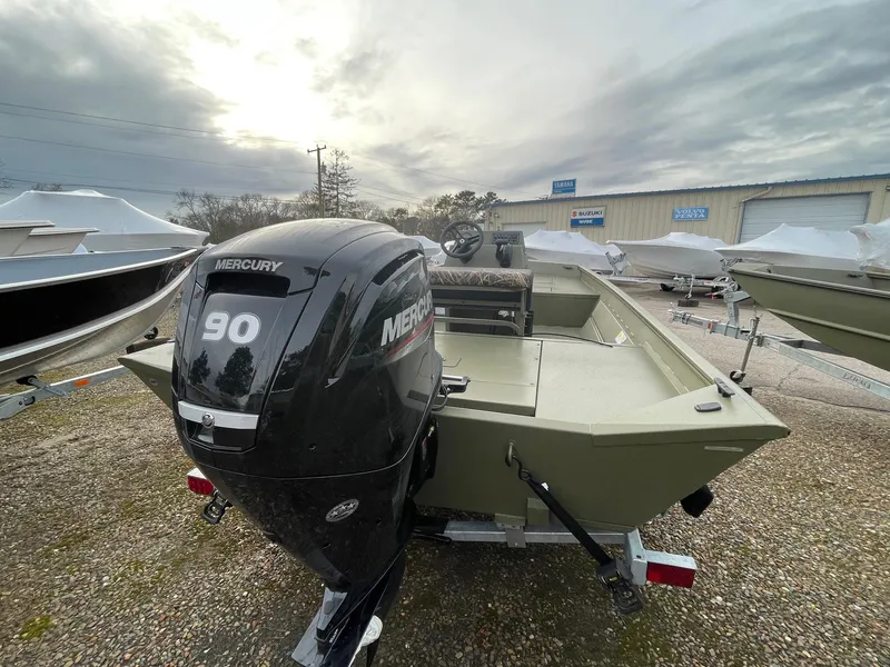 Slide: The Image of 2024 Lund 1870 Predator boat with Mercury 90 outboard motor in a boatyard. - 2