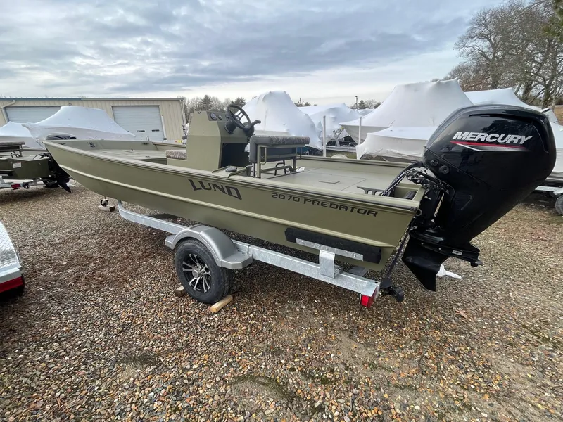 The Image of 2024 Lund 2070 Predator boat with Mercury outboard motor on a trailer. - 0