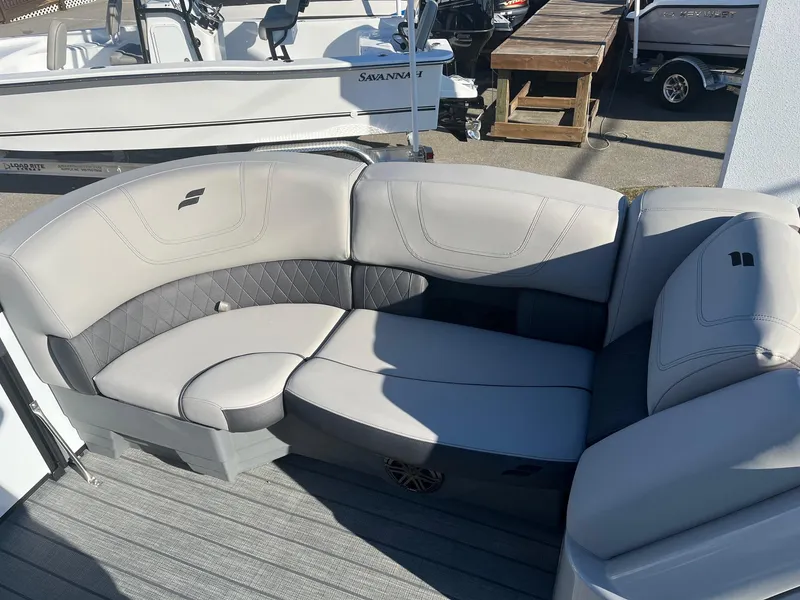 Slide: The Image of 2024 Starcraft SLS3 boat with luxurious seating in a marina. - 4