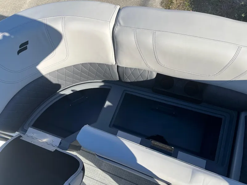Slide: The Image of 2024 Starcraft SLS3 boat interior with gray seating and storage compartment. - 14