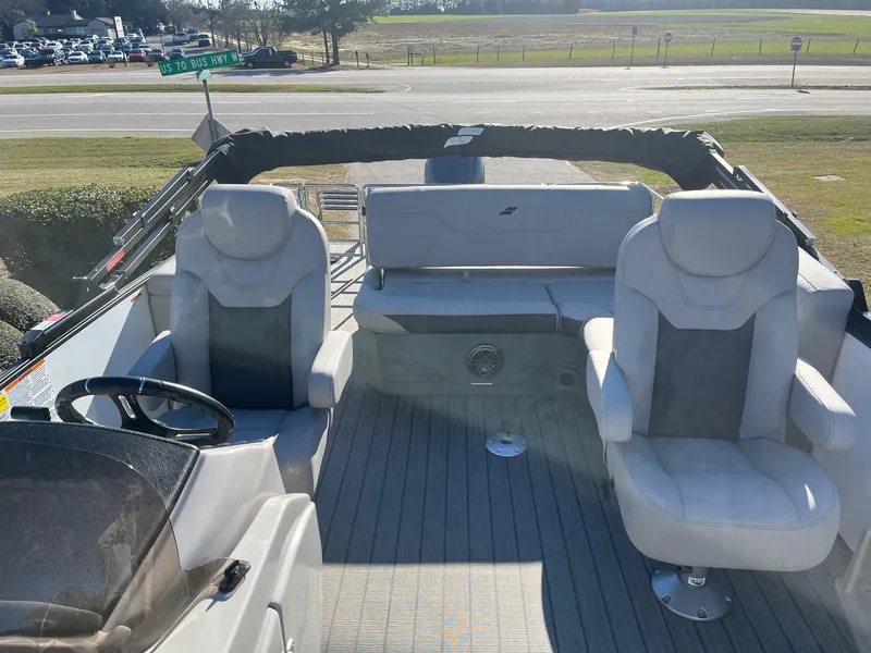 Slide: The Image of 2024 Starcraft SLS3 boat interior with white seating and steering wheel. - 6