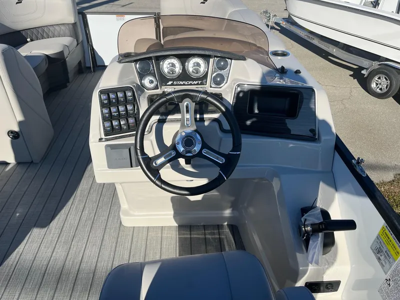 Slide: The Image of 2024 Starcraft SLS3 boat dashboard with steering wheel and control panel. - 8