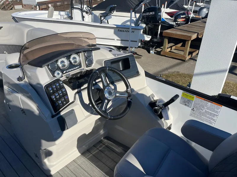 Slide: The Image of 2024 Starcraft SLS3 boat dashboard with steering wheel and control panel. - 7