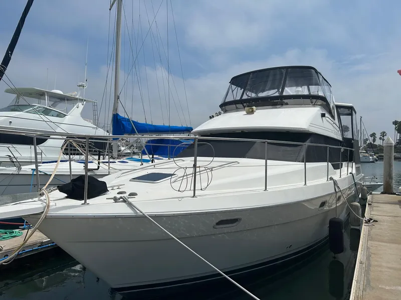 The Image of 1994 Bayliner 4587 Motoryacht docked at marina under clear sky. - 0