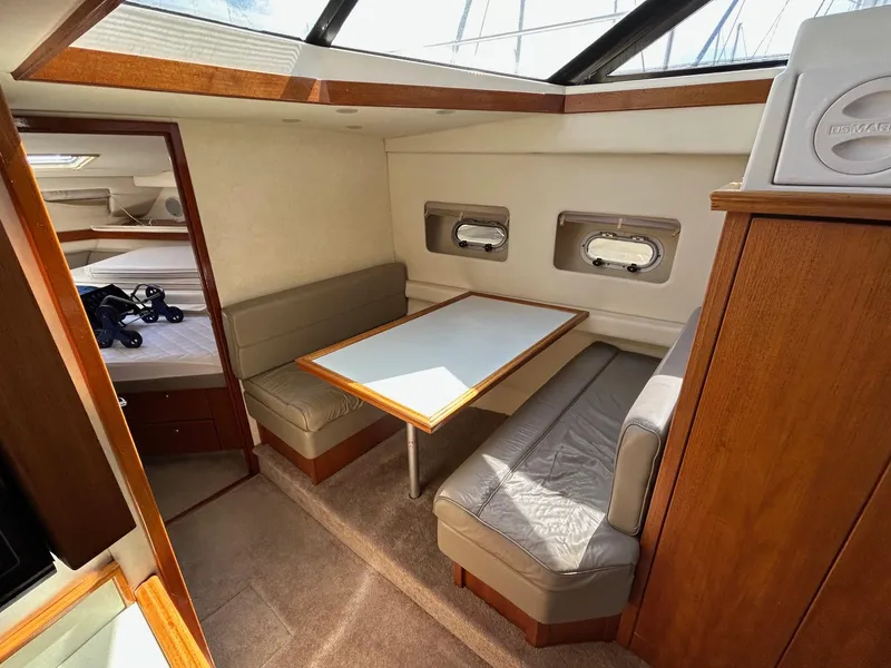 Slide: The Image of 1994 Bayliner 4587 Motoryacht interior with dining area, table, and seating. - 10