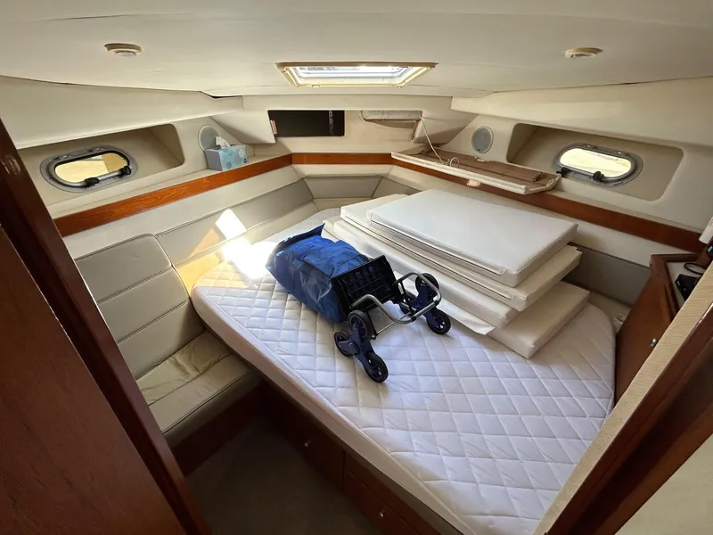Slide: The Image of 1994 Bayliner 4587 Motoryacht cabin with mattress, cushions, and a folded stroller. - 11