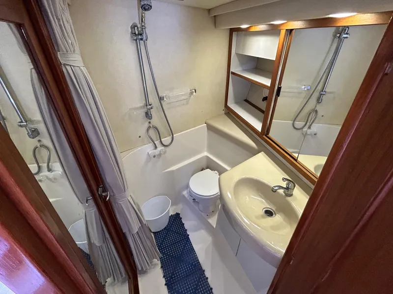 Slide: The Image of 1994 Bayliner 4587 Motoryacht bathroom with shower, sink, and mirror cabinet. - 12