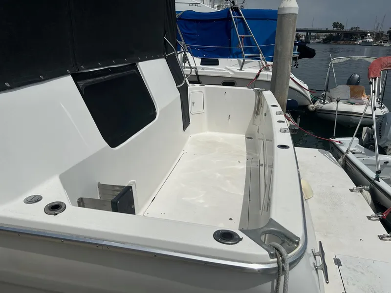 Slide: The Image of 1994 Bayliner 4587 Motoryacht docked, featuring spacious deck area and mooring lines. - 2