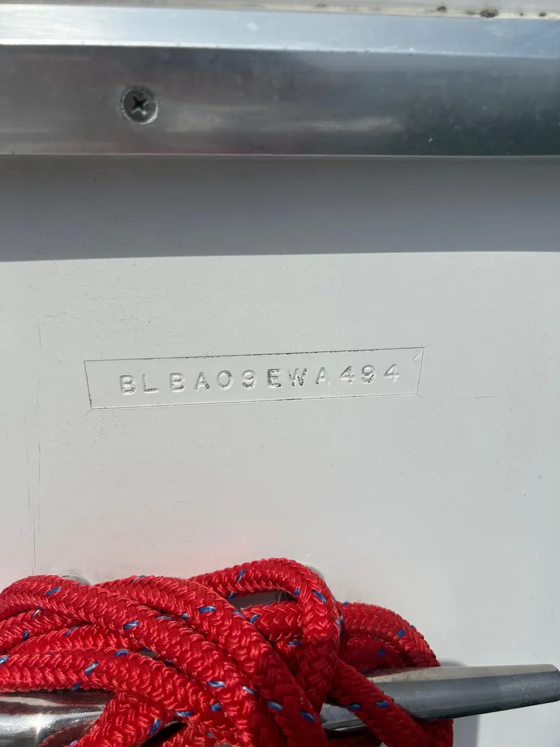 Slide: The Image of 1994 Bayliner 4587 Motoryacht hull identification number with red rope detail. - 3