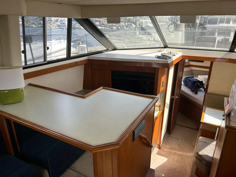 Slide: The Image of Interior of 1994 Bayliner 4587 Motoryacht with spacious seating and large windows. - 5