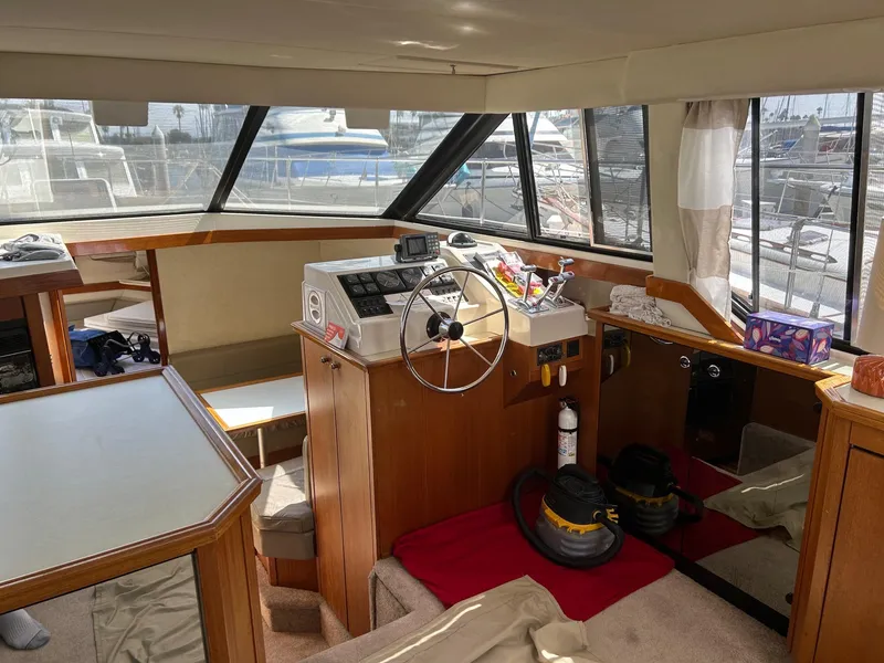 Slide: The Image of Interior of 1994 Bayliner 4587 Motoryacht with helm, windows, and nautical equipment. - 7