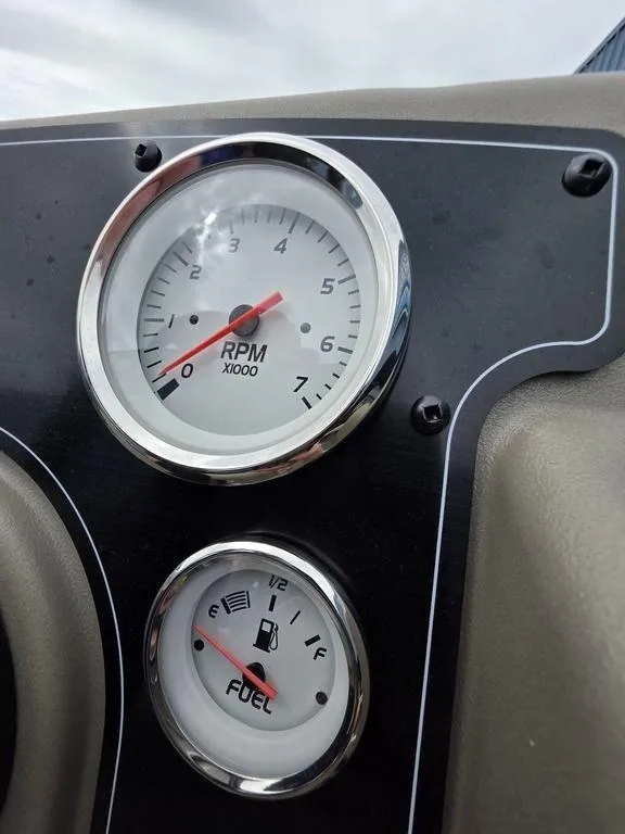 Slide: The Image of Dashboard gauges of 2025 Sun Tracker BASS BUGGY® 18 DLX showing RPM and fuel levels. - 10