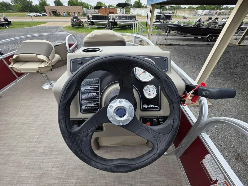 Slide: The Image of Steering console of 2025 Sun Tracker BASS BUGGY® 18 DLX pontoon boat, featuring gauges and controls. - 12