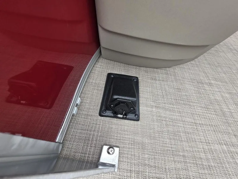 Slide: The Image of 2025 Sun Tracker BASS BUGGY® 18 DLX interior detail with carpeted flooring and black fixture. - 16