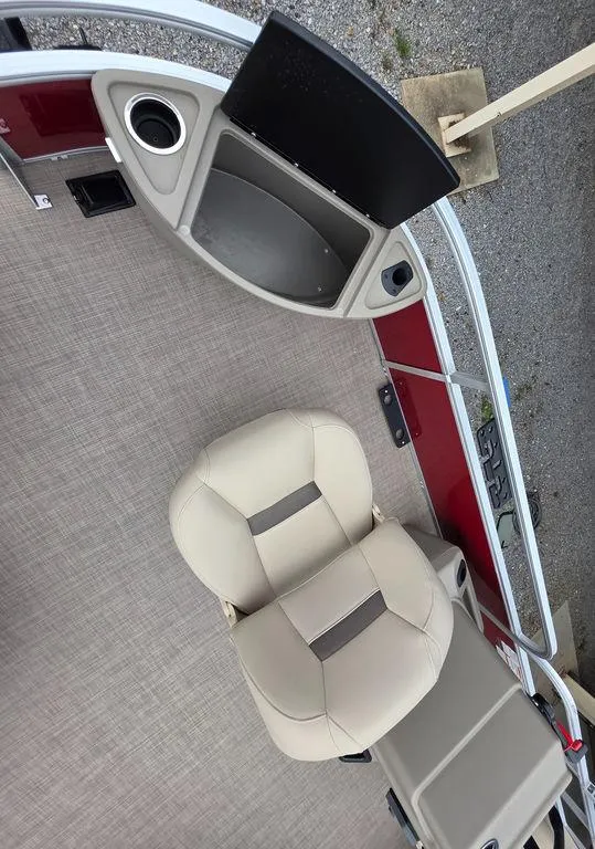 Slide: The Image of 2025 Sun Tracker BASS BUGGY® 18 DLX interior with beige seats and control panel. - 18