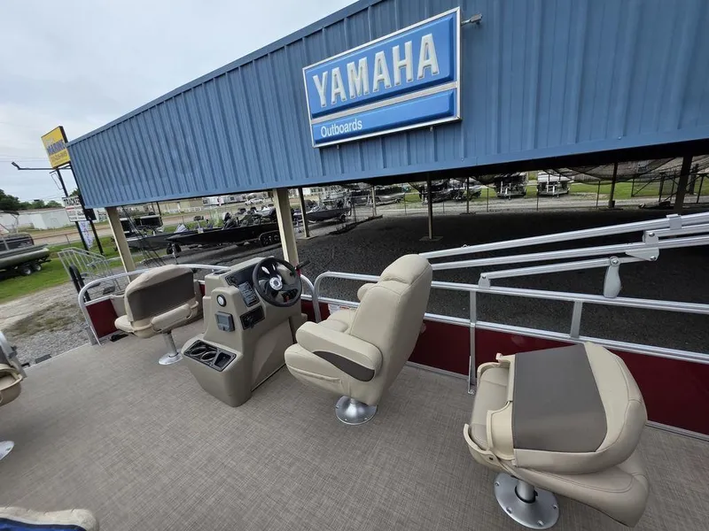 Slide: The Image of 2025 Sun Tracker BASS BUGGY® 18 DLX pontoon boat interior at Yamaha dealership. - 2