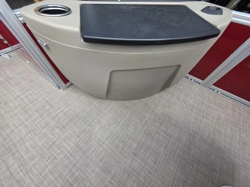 Slide: The Image of 2025 Sun Tracker BASS BUGGY® 18 DLX boat interior with beige console and cup holder. - 3