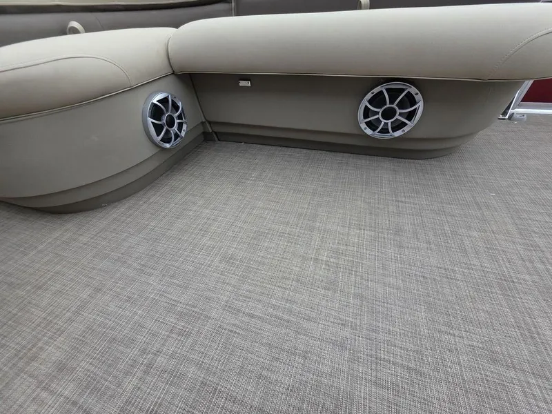 Slide: The Image of 2025 Sun Tracker BASS BUGGY® 18 DLX interior with beige seating and built-in speakers. - 7