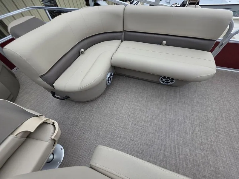 Slide: The Image of 2025 Sun Tracker BASS BUGGY® 18 DLX pontoon boat seating with beige upholstery and speakers. - 8