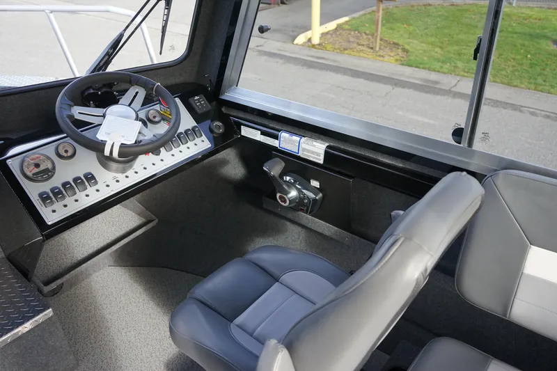 Slide: The Image of 2024 Thunder Jet 24 Alexis Pro HT boat interior with steering wheel and seating. - 10