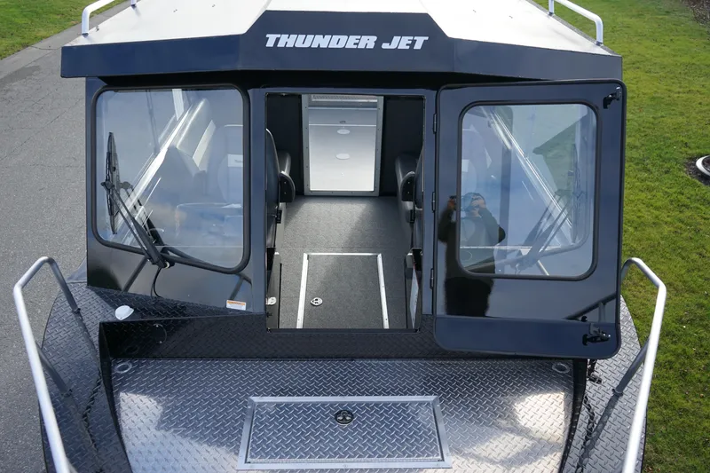 Slide: The Image of 2024 Thunder Jet 24 Alexis Pro HT boat, front view with open cabin doors. - 15