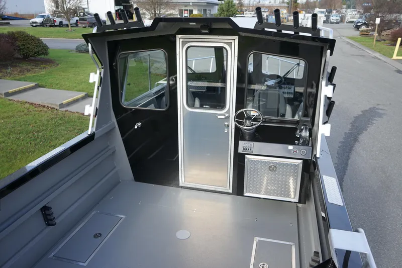 Slide: The Image of 2024 Thunder Jet 24 Alexis Pro HT boat interior with steering console and storage compartments. - 6