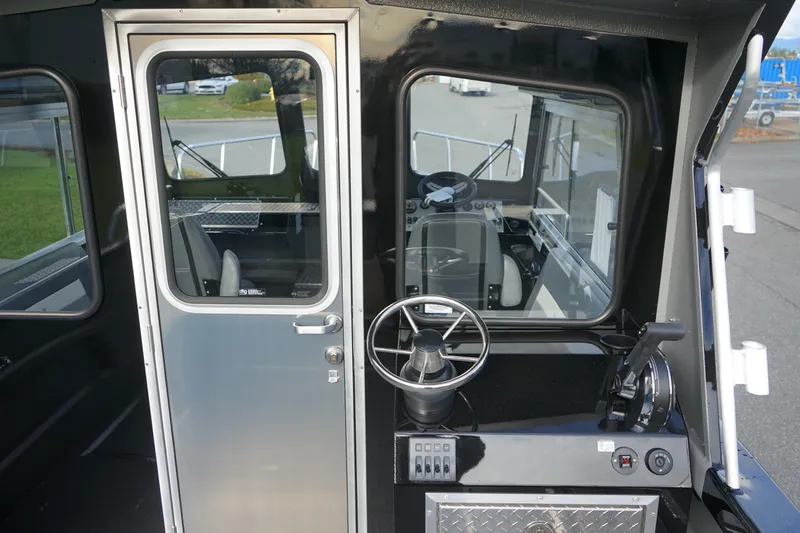 Slide: The Image of 2024 Thunder Jet 24 Alexis Pro HT boat interior with steering wheel and control panel. - 7