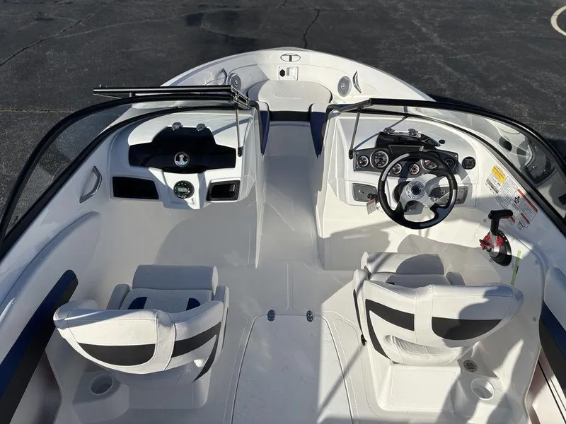 Slide: The Image of 2024 Tahoe 200 S boat interior with dual seating and modern dashboard controls. - 10
