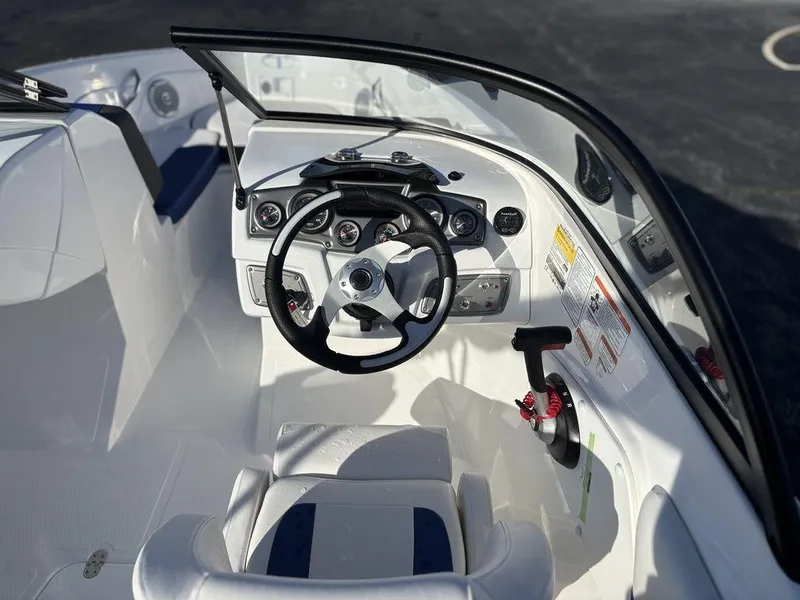 Slide: The Image of 2024 Tahoe 200 S boat interior with steering wheel and dashboard controls. - 12