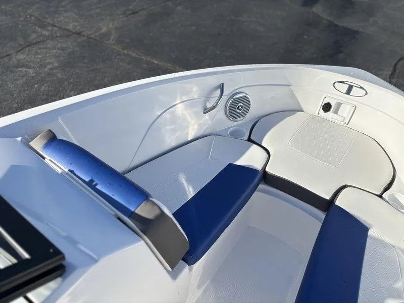 Slide: The Image of 2024 Tahoe 200 S boat interior with blue and white seating and speaker system. - 14