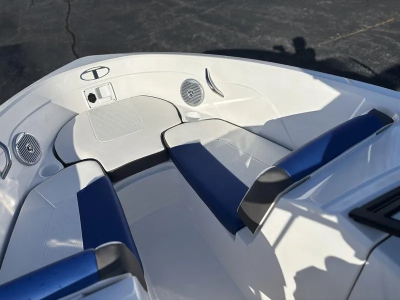 Slide: The Image of 2024 Tahoe 200 S boat interior with blue and white seating and built-in speakers. - 16